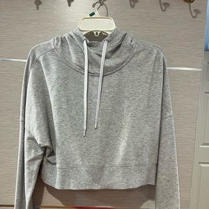 Beautiful grey sweatshirt with hoodie and zipper on the back.